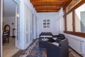 Covered veranda sitting area with view of the lake