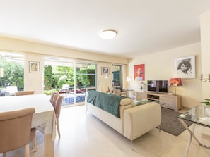 Living room, dining table, sofa, tv, wifi, AC, open on the south terrace