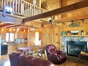 The kitchen opens to the living room and has a table with a leaf to seat up to 8