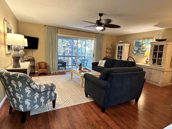 Spacious open-concept living area with sliders onto the balcony