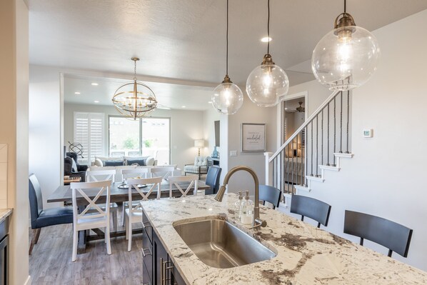 Kitchen View - The kitchen is fully stocked with all the dishes, cookware, baking pans, and cutlery you will need for meal preparations and includes stainless steel appliances and granite counter tops.