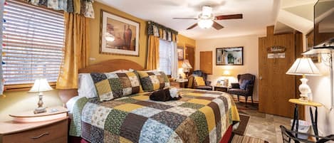 Comfortable king size bed with 4 pillows, office space, and private bathroom.