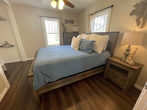Queen bedroom off the kitchen with a tall dresser and closet. USBs in dresser.
