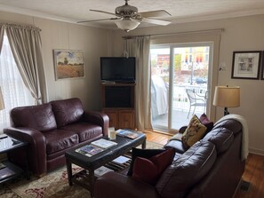 Living room with 40” Chromecast  TV and access to deck