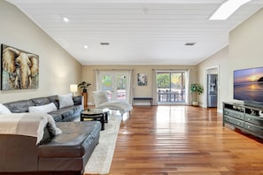 Watch a movie and enjoy the view of the beautiful backyard and saltwater pool.