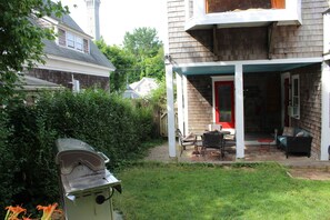 View from the yard to the porch. Yard is fenced with 6 foot privacy fence.