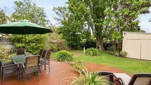 Rear deck overlooking well maintained garden.