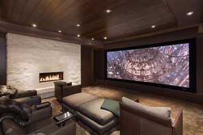 Theatre room with comfy couches and fireplace