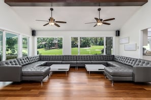 Custom leather sofa that seats up to 20 guests in this living room.High ceilings