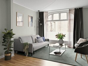 Spacious and bright living room with a comfortable sofa bed.