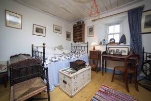 Sitting Room/Bedroom 4 with toliet, sink; writing table; dining table wood stove