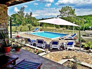 View of the heated swimming pool from the terrace with the sun loungers