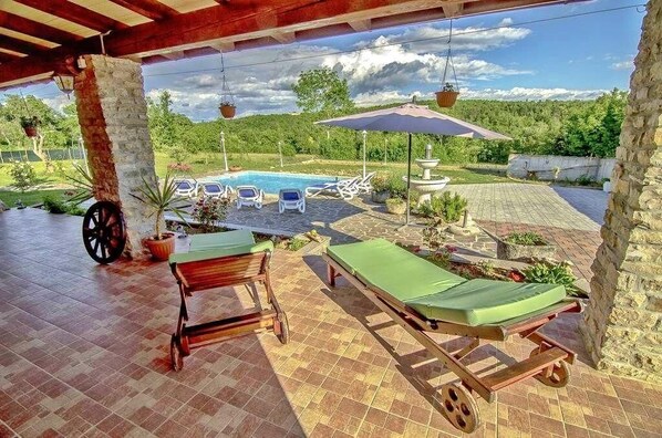 View of the heated swimming pool from the terrace with the sun loungers
