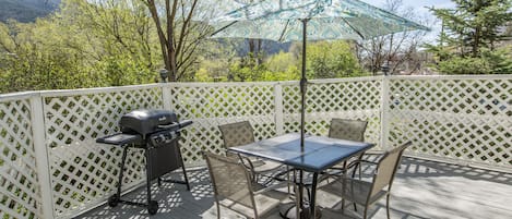 Deck has a table set and gas grill. This has since been remodeled, see new pics