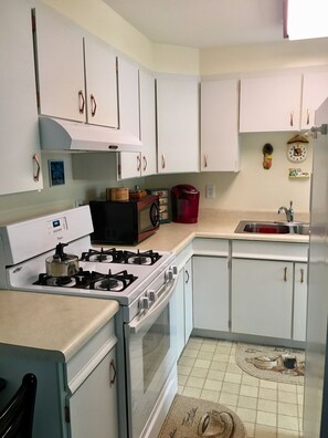 Kitchen with gas range, microwave, Keurig coffee maker  