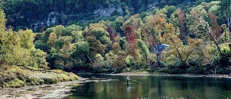 A beautiful fall day captures a fly fisherman in the shoals just below our dock.