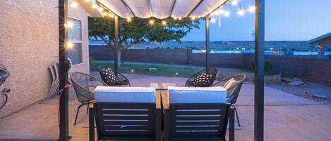 Outside area with seating & a 4 burner gas grill to enjoy sunset