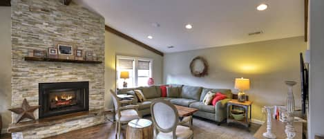 Main Street Cottage- Living room area with a fireplace