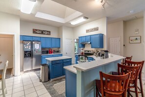 Large kitchen, equipped with the essentials to make long-term stays easy.  