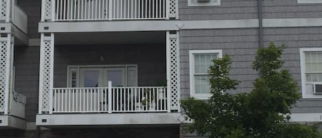 Exterior photo of our third floor condo unit which includes 2 outdoor chairs.