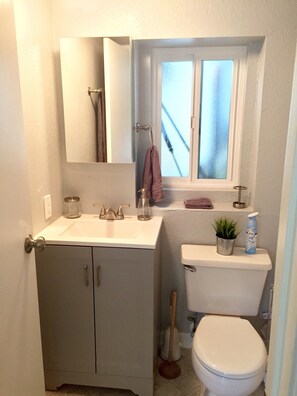 bathroom has a full sized tub shower