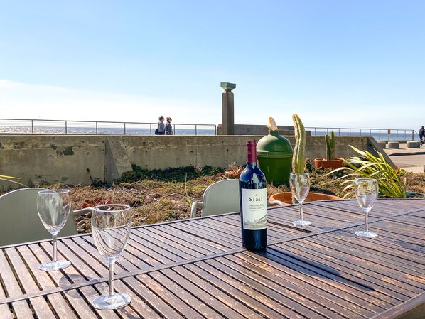 Enjoy a glass of wine while you listen to the waves.