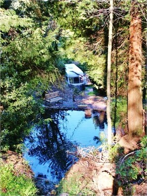 Looking down on waterfalls pool and caravan