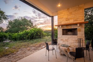 Enjoy the outdoor fireplace under the patio