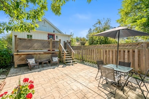 Private backyard patio with seating, charcoal BBQ(bring your own coal), umbrella