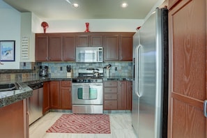 Remodeled, fully equipped kitchen with granite countertops, and full-size stainless steel appliances.