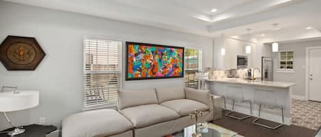 Living room open to the kitchen with large smart tv