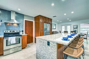 Modern  kitchen with extra bar seating for 5.  Cherry cabinets and quality stainless appliances.