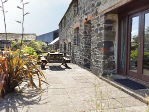 Paved patio area at entrance | Haywain - Trentinney Farm Holiday Cottages, St Endellion, near Port Isaac