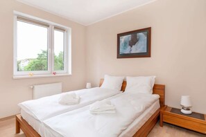 Comfortable bedroom with a double bed and a closet.