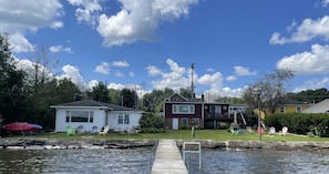 The lakefront property with both cottages shared dock, yard and kayaks