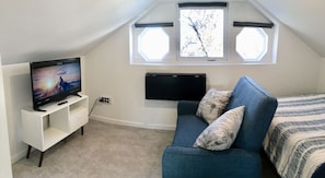 Loveseat recliner, 39-inch TV, and drop-down desk.