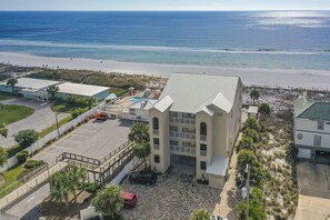 Street view, parking in front of building, with a walkthru to the pool and beach