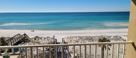 Balcony view of the Emerald waters and white sand just steps away!