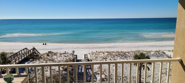 Balcony view of the Emerald waters and white sand just steps away!