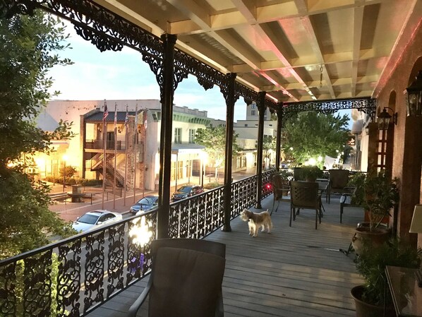 Watch downtown nightlife spring to life as you enjoy cocktails on the balcony 