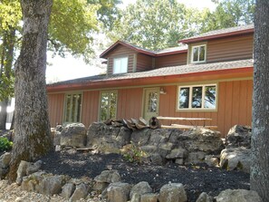 side of cabin with picnic tables and fire pit