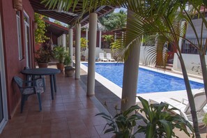 The poolside patio with sliding doors from the living room and master bedroom.