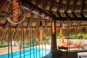 View from kitchen towards the pool and swinging lounge bed. 