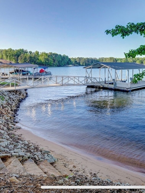 Concrete path and stone slab steps leading to amazing sandy beach.