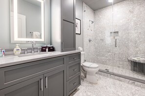 Ensuite Master Bathroom featuring large frameless glass Italian marble shower. Enjoy plush towels, blow dryer and complimentary travel size shampoo, conditioner, body wash, tooth brushes (2), tooth paste, mouth wash, lotion and makeup remover wipes.