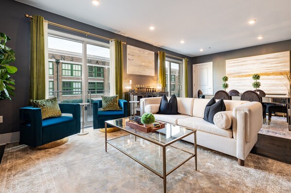 Open-concept living, kitchen, and dining area. 65” Samsung Smart TV that allows for streaming from your favorite apps, along with DIRECTV Entertainment.