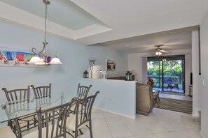 Living room looks out on private screen in lanai area.