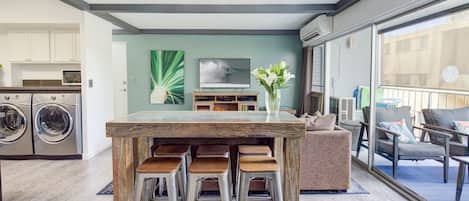 LIVING ROOM: Bar height dining table with six chairs.