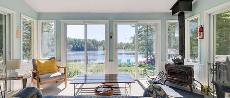 The Sun Room overlooking the Lake with wood fireplace is a room you will never want to leave