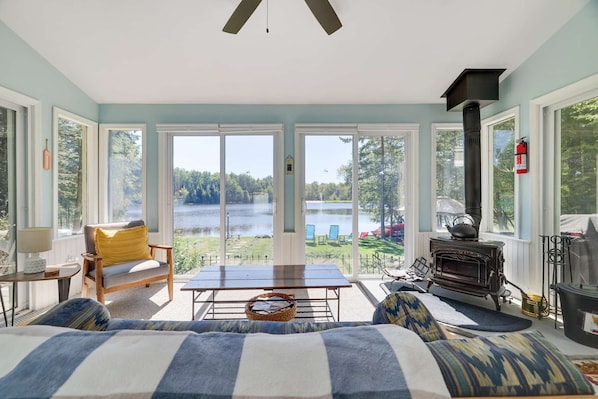 The Sun Room overlooking the Lake with wood fireplace is a room you will never want to leave